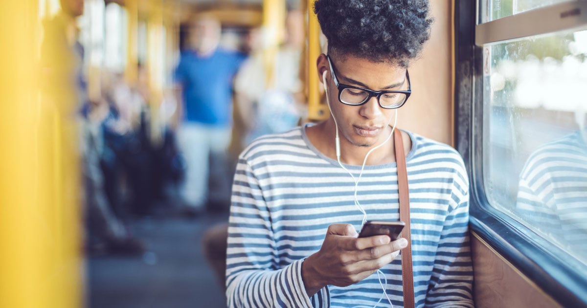 Person riding public transit and listening to headphones